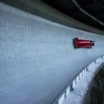 An Athlete Riding a Bobsled on an Ice Track