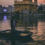 Man riding a boat at night